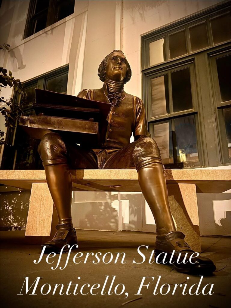Statue of Thomas Jefferson seated on a bench in Monticello
