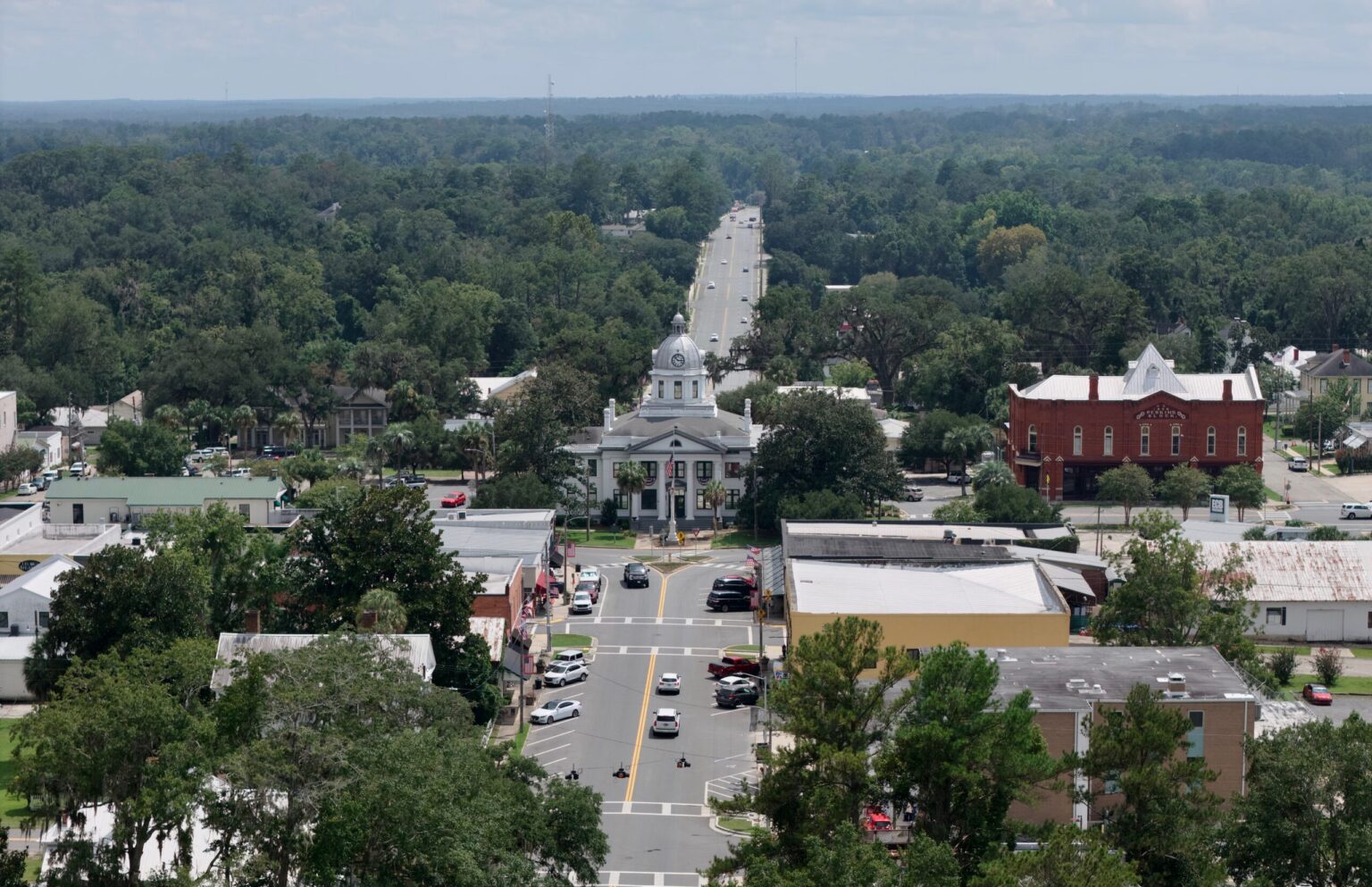 Aerial view looking down Highway 19 through downtown Monticello with the courthouse at center